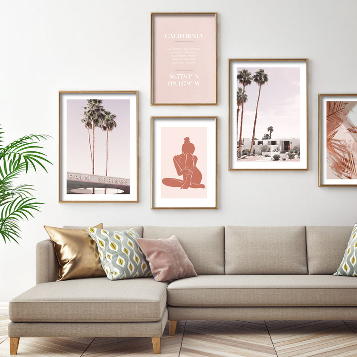 Print of the Palm Springs sign in a light grey theme living room in a long sofa and decorative pillows