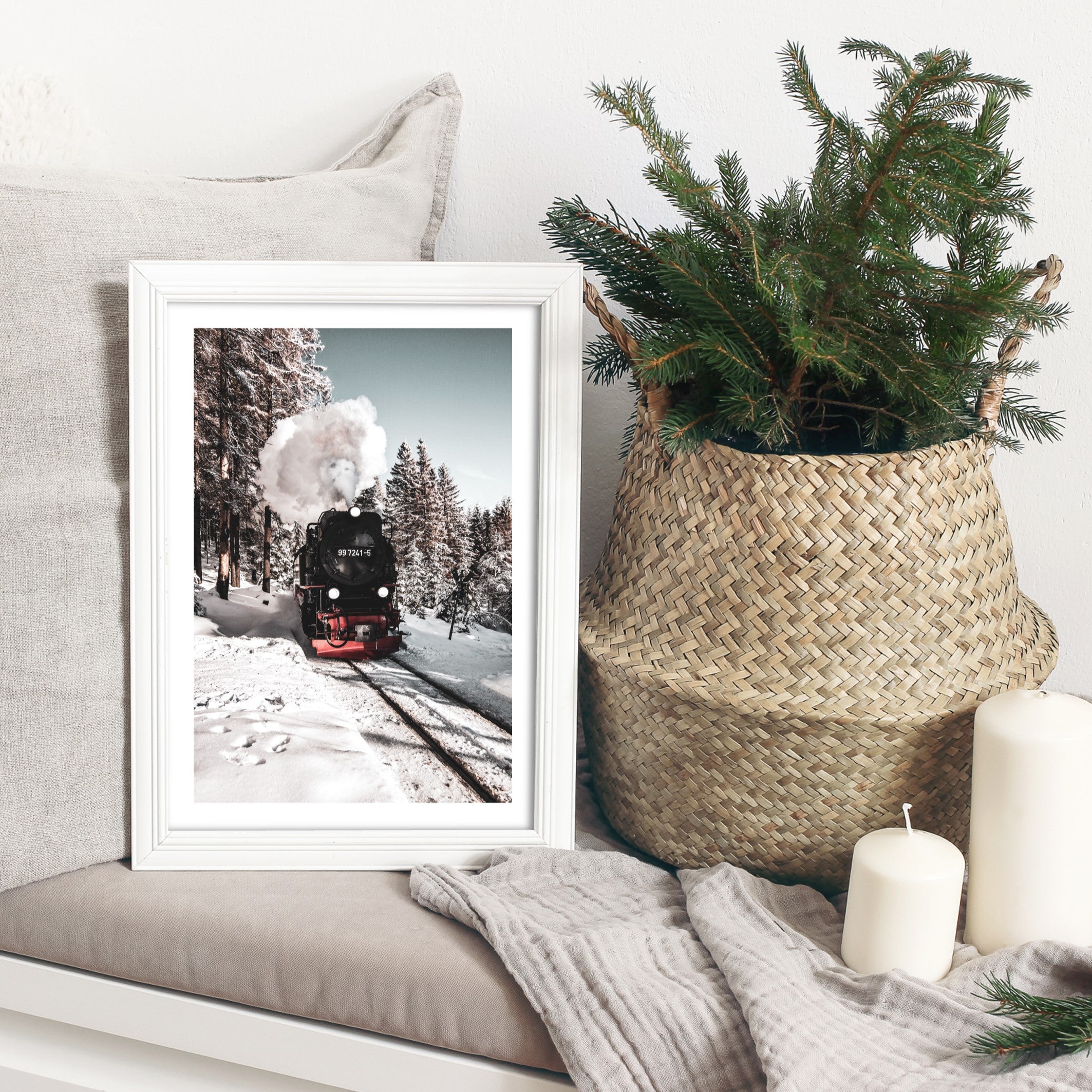 snow train wall art next to a christmas tree