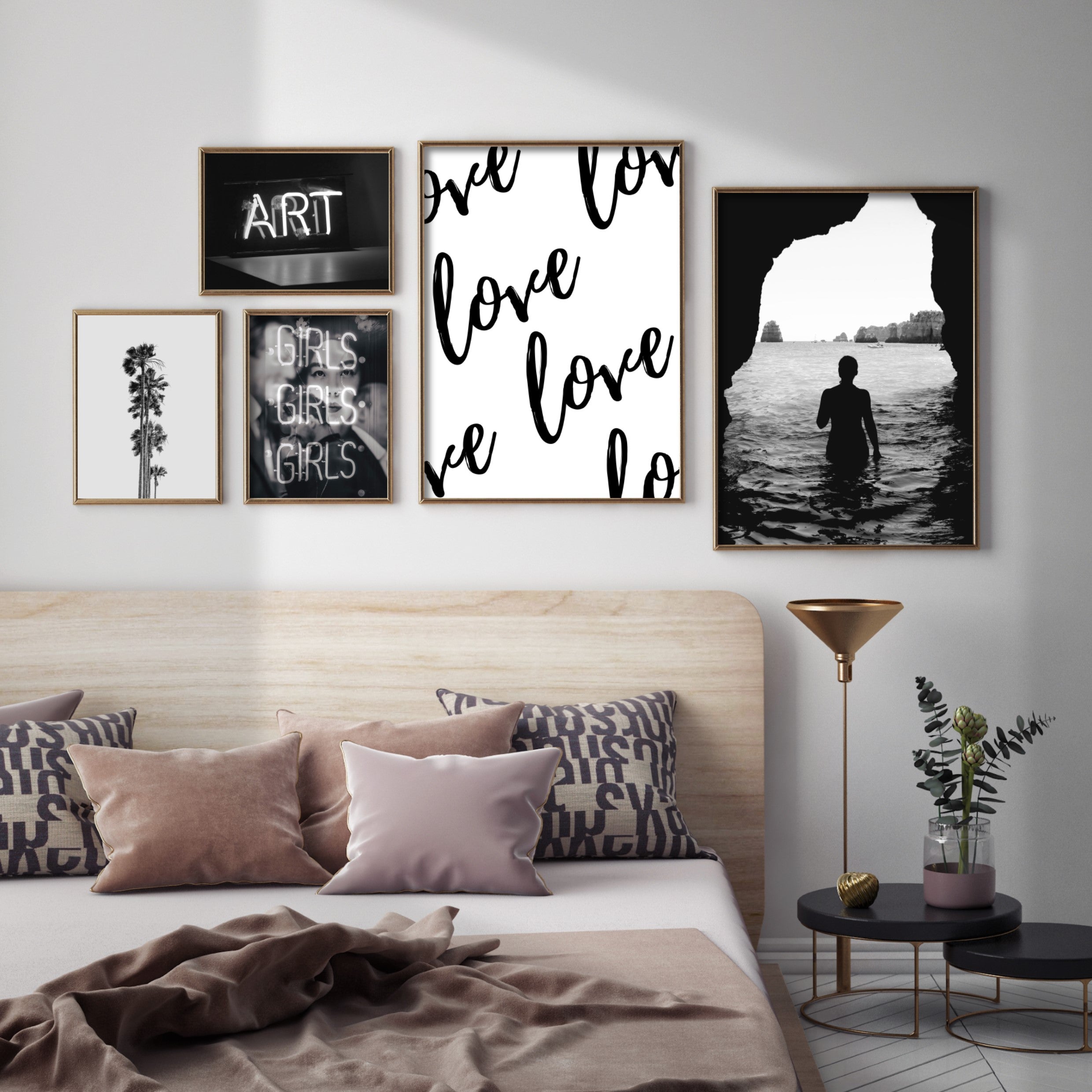 black and white gallery wall above a bed