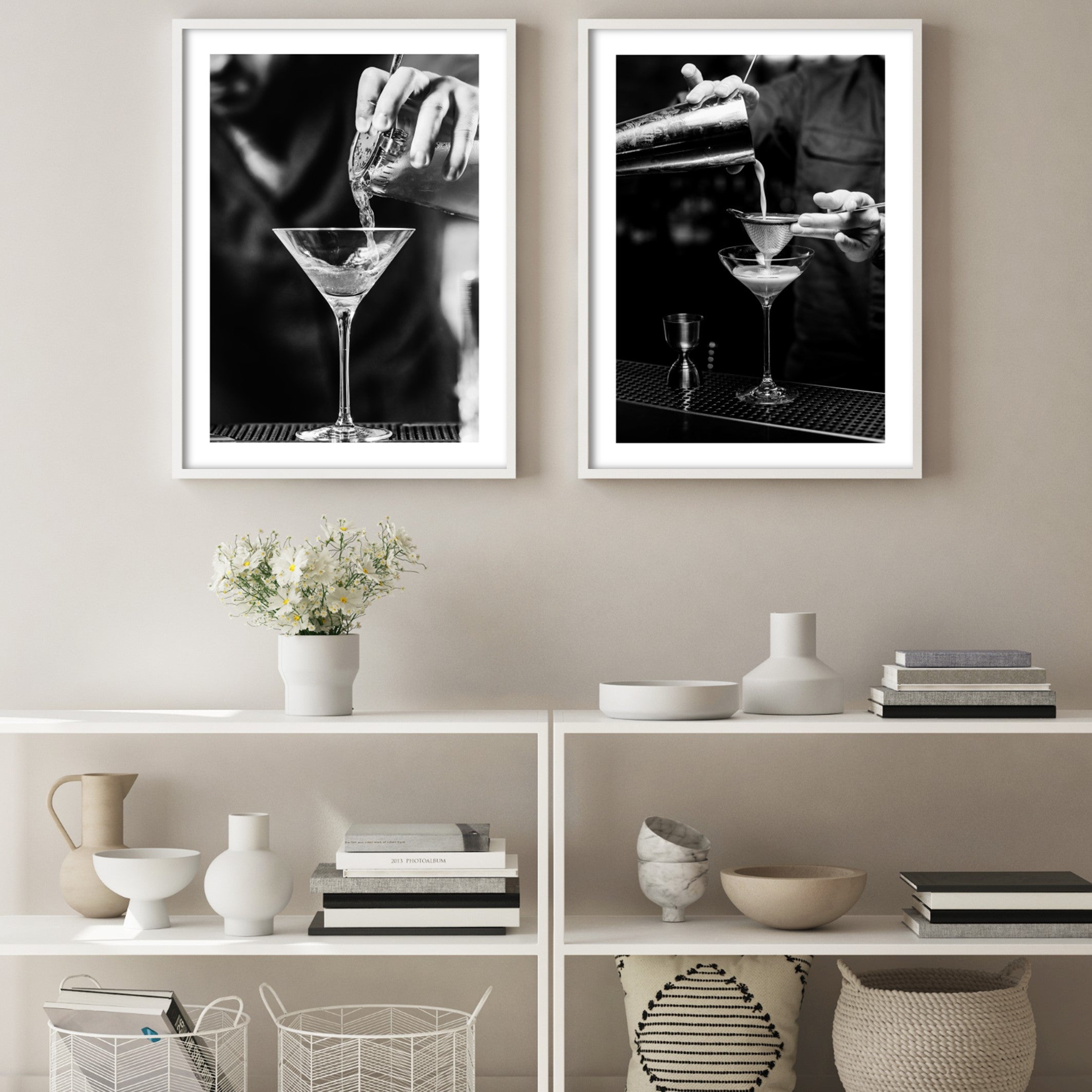 two posters of cocktail mixologists in a scandi living room