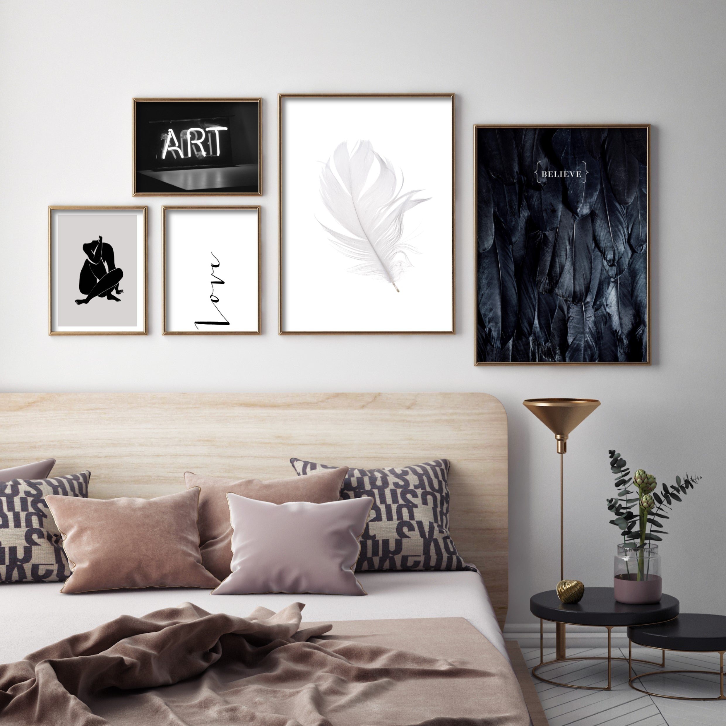 monochrome gallery wall in bedroom with gold poster frames