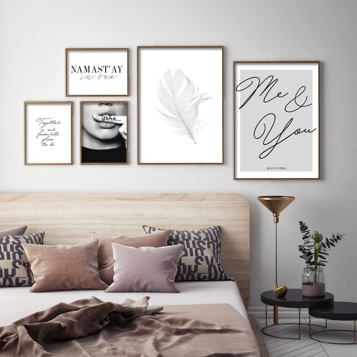 bedroom gallery wall in modern room with gold poster frames and stylish prints