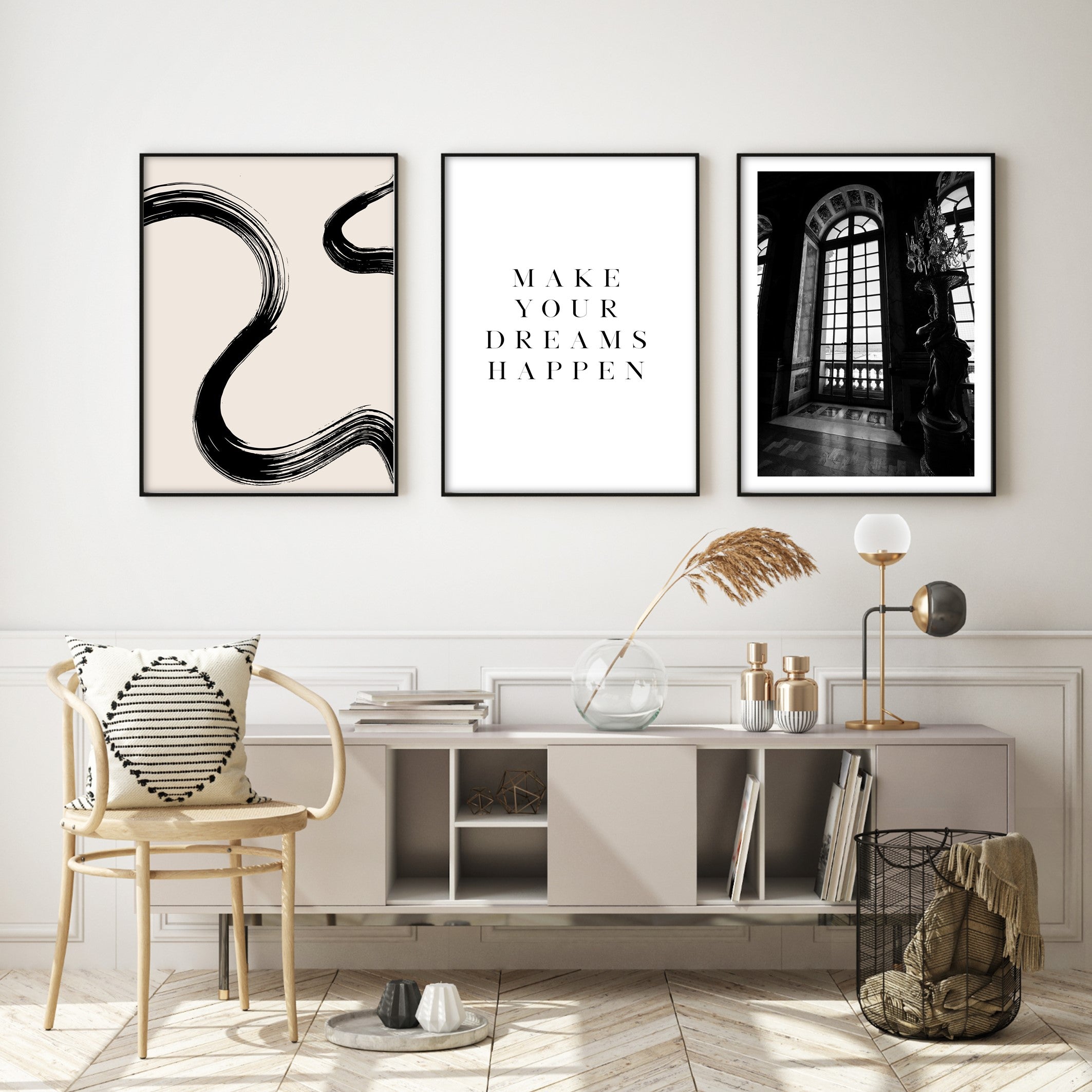 black and white wall art in a modern living room with gold accessories